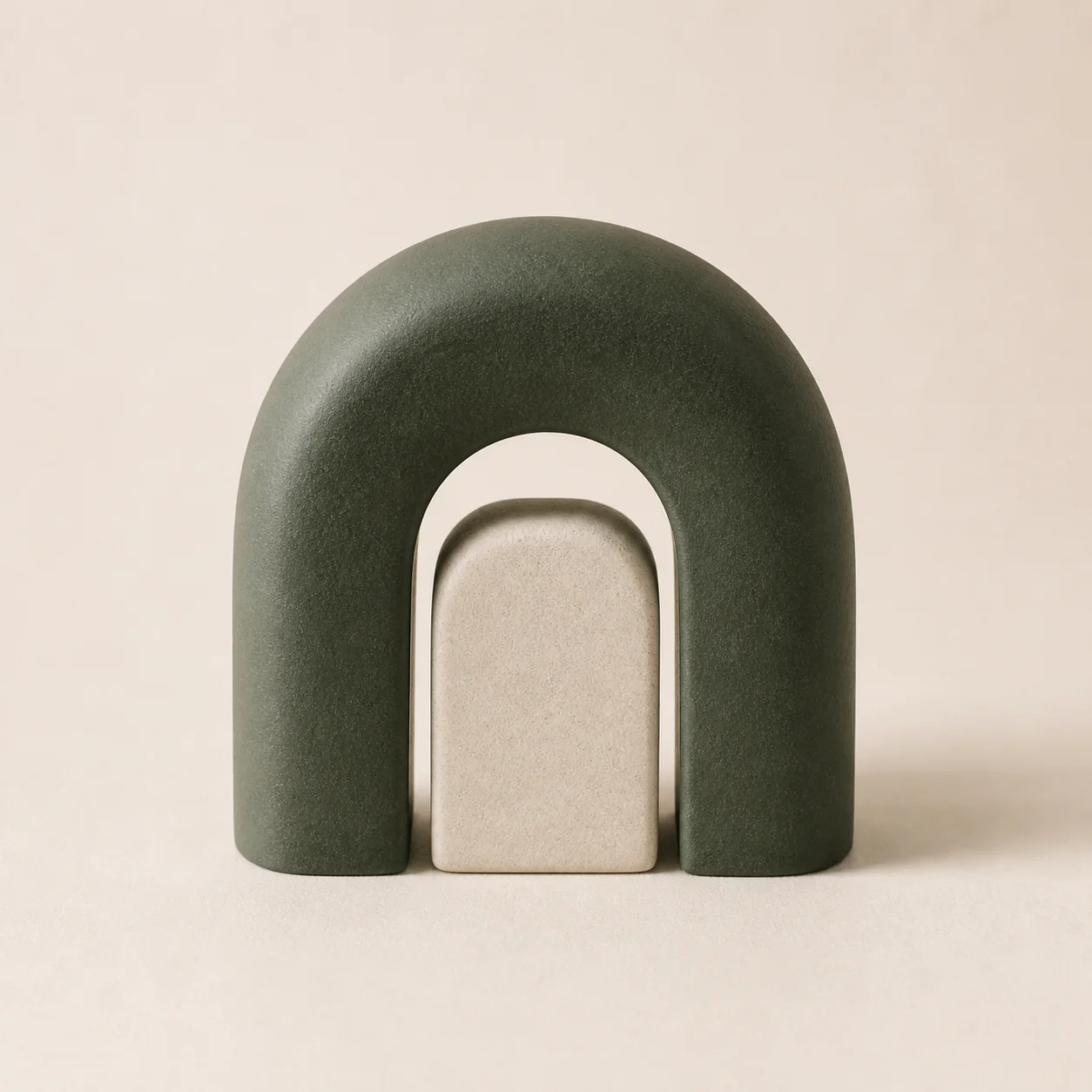 A green ceramic arch protecting a smaller stone form